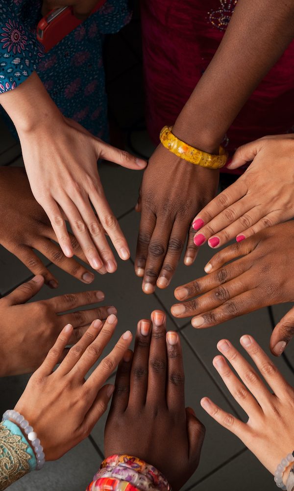 Hands of happy group of African people which stay together in circle happy